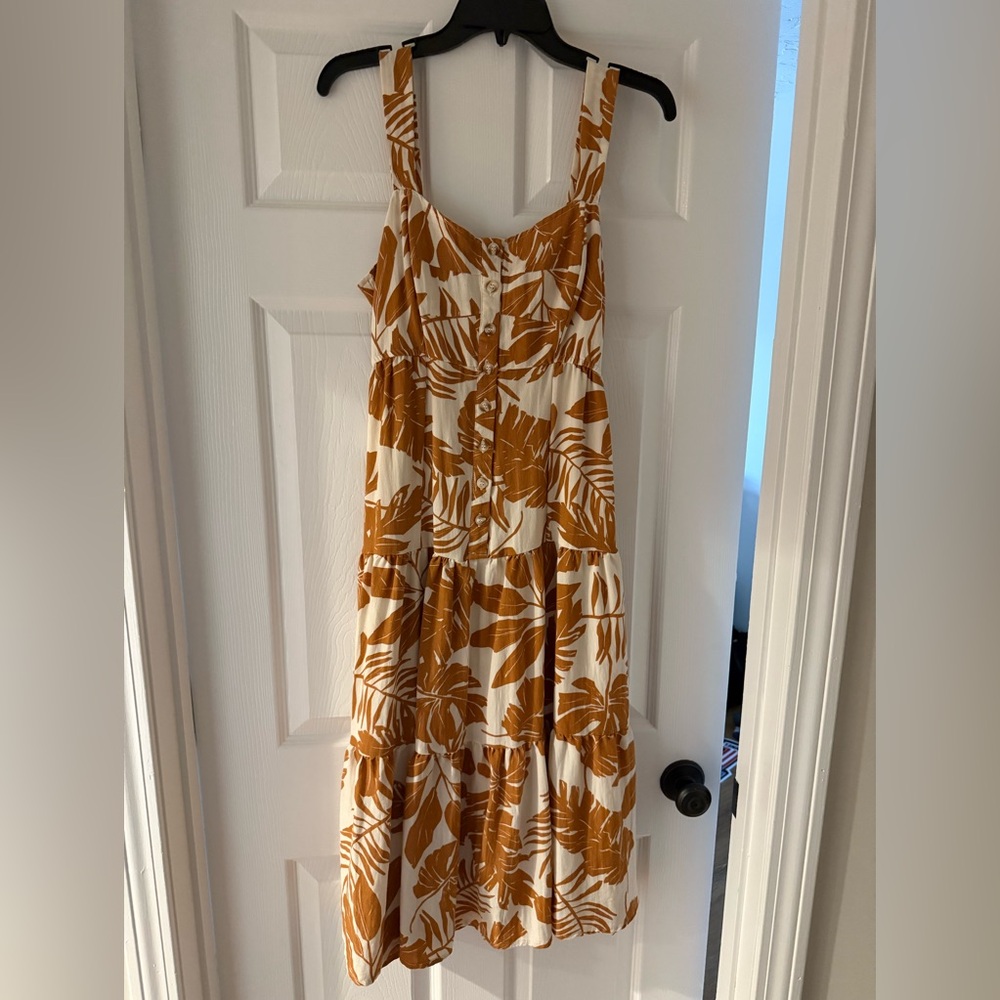 This dress is a bronze and white color, size medium, and in perfect condition.